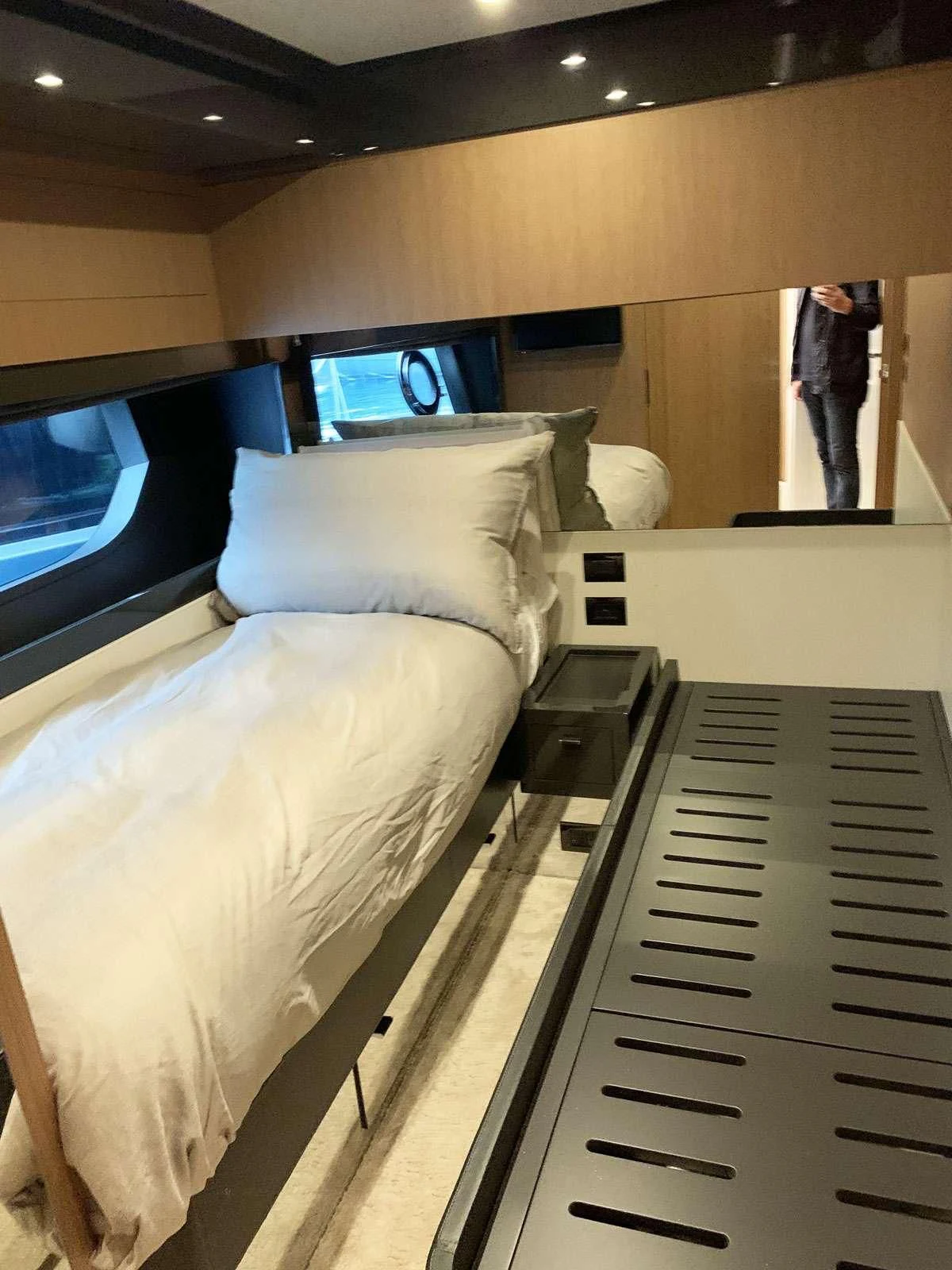a bed with a television on the wall aboard CHILUCE Yacht for Charter