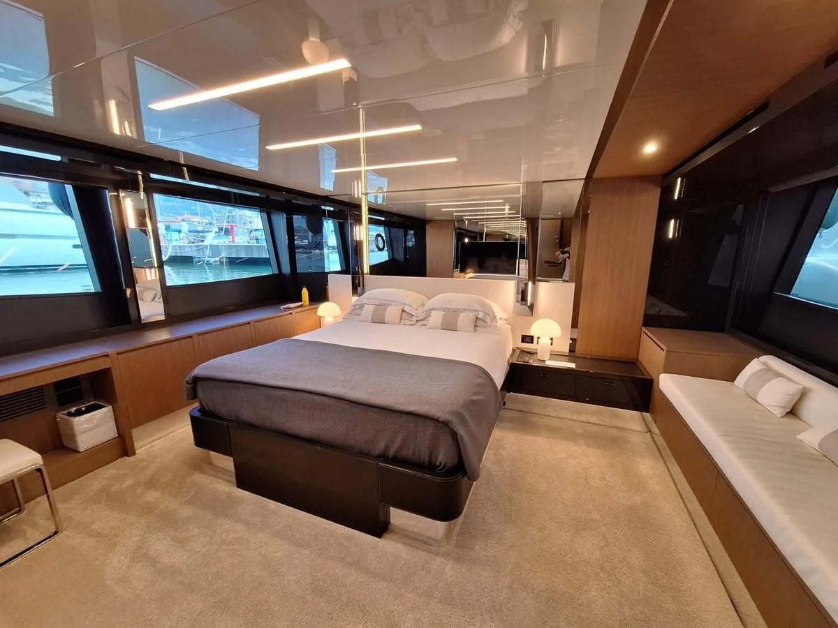 a room with a bed and a tv aboard CHILUCE Yacht for Charter