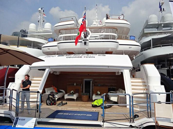 a person standing on a deck of a ship aboard MY ESCAPE Yacht for Sale