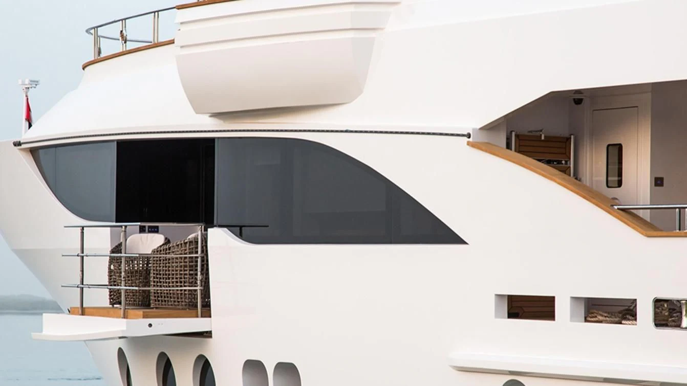 a white building with a balcony aboard MY ESCAPE Yacht for Sale