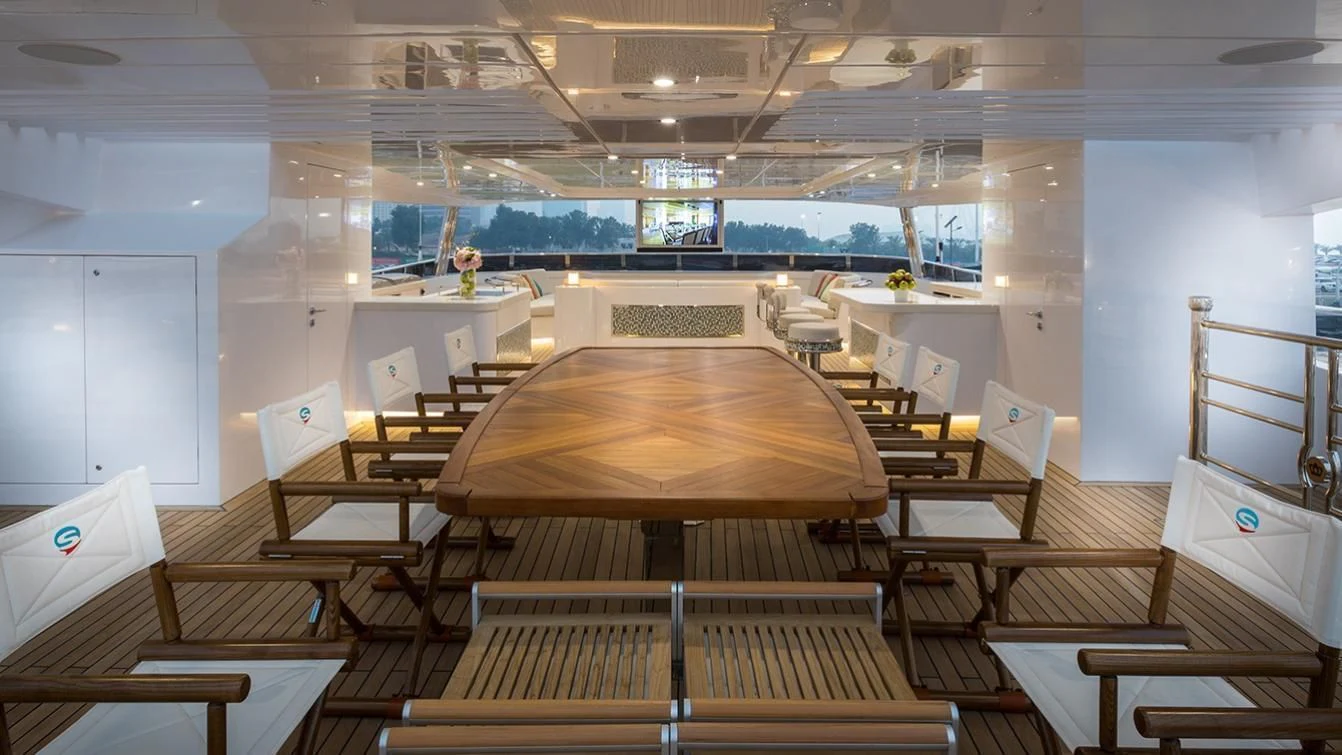 a room with tables and chairs aboard MY ESCAPE Yacht for Sale