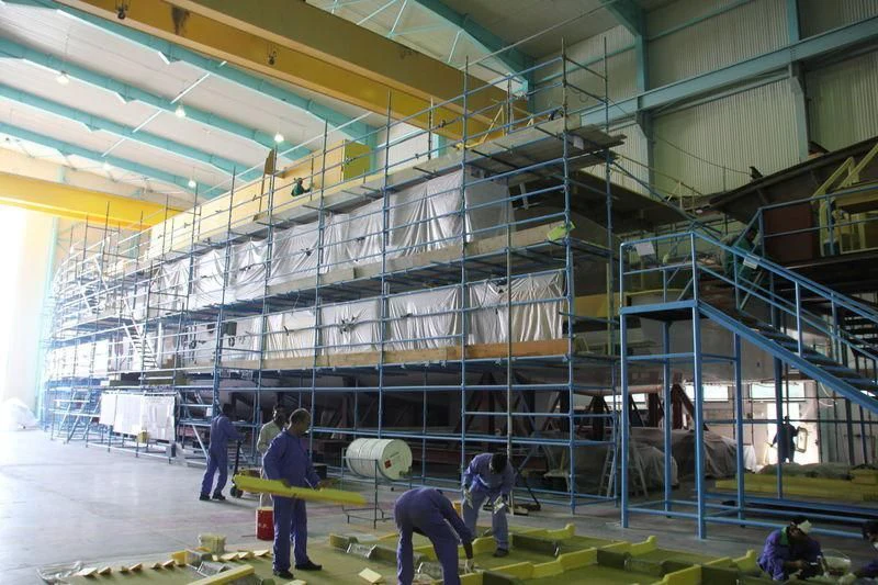 a group of people working in a factory aboard MY ESCAPE Yacht for Sale