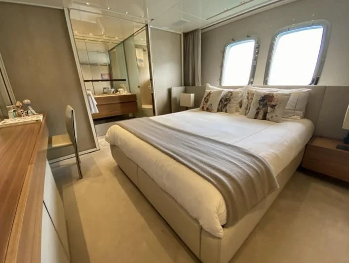 a bedroom with a bed and a window aboard ENSO 4 Yacht for Sale