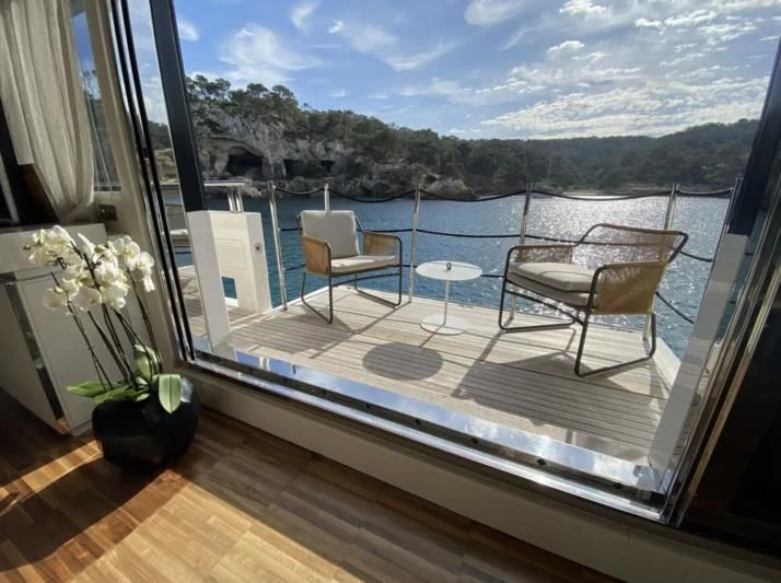 a room with a view of the mountains and the ocean aboard ENSO 4 Yacht for Sale