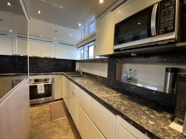 a kitchen with a microwave oven and a countertop aboard ENSO 4 Yacht for Sale