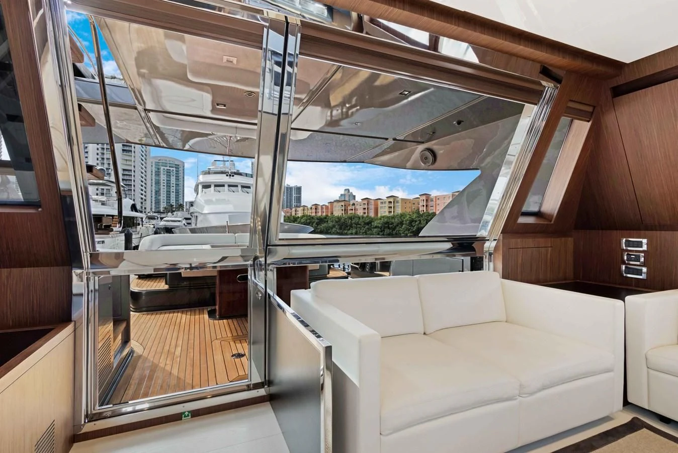 a room with a couch and a view of the water aboard INDISCRETION Yacht for Sale
