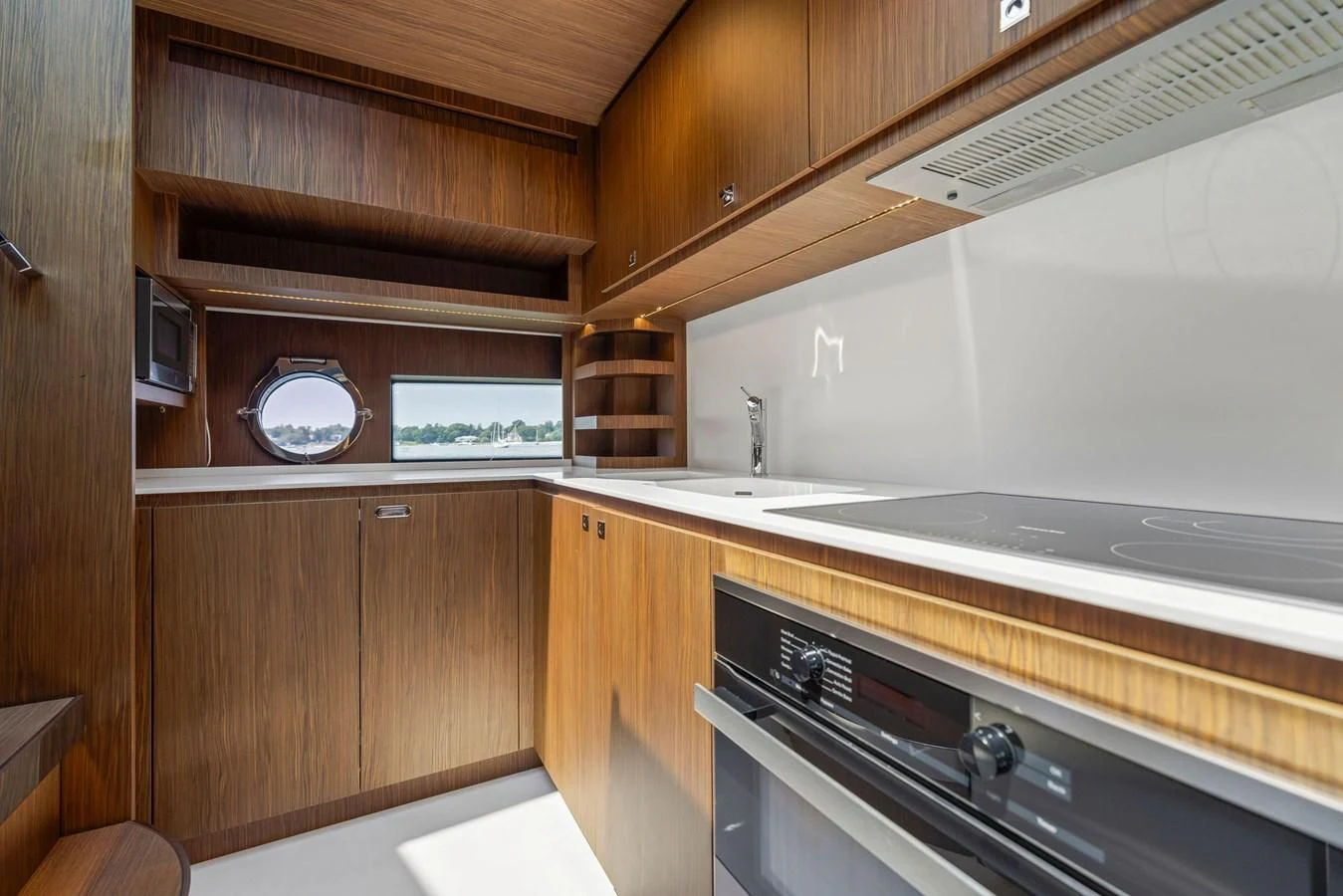 a kitchen with wooden cabinets aboard INDISCRETION Yacht for Sale