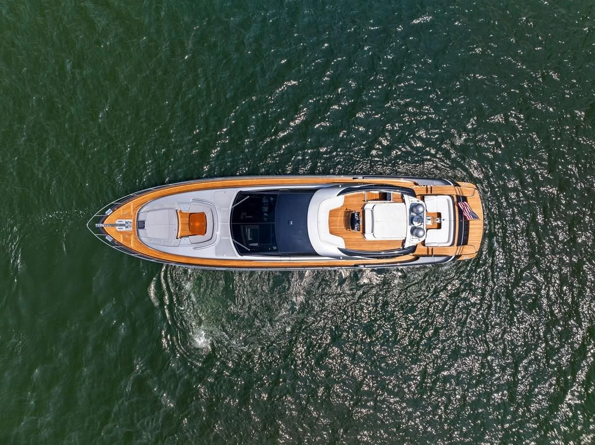 a yellow and blue sports car in the grass aboard INDISCRETION Yacht for Sale