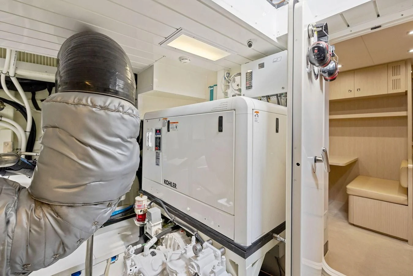 a person in a mask looking at a refrigerator aboard INDISCRETION Yacht for Sale