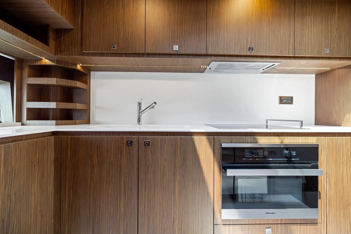 a kitchen with wooden cabinets aboard INDISCRETION Yacht for Sale