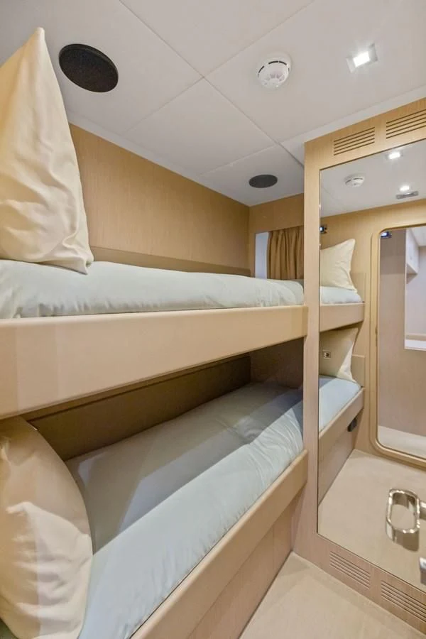 a room with a bed and a mirror aboard INDISCRETION Yacht for Sale