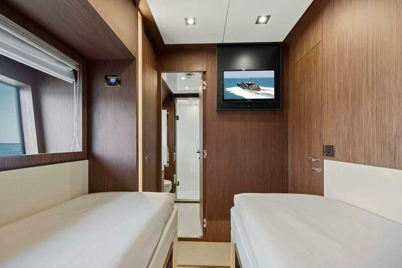 a room with a bed and a television in it aboard INDISCRETION Yacht for Sale
