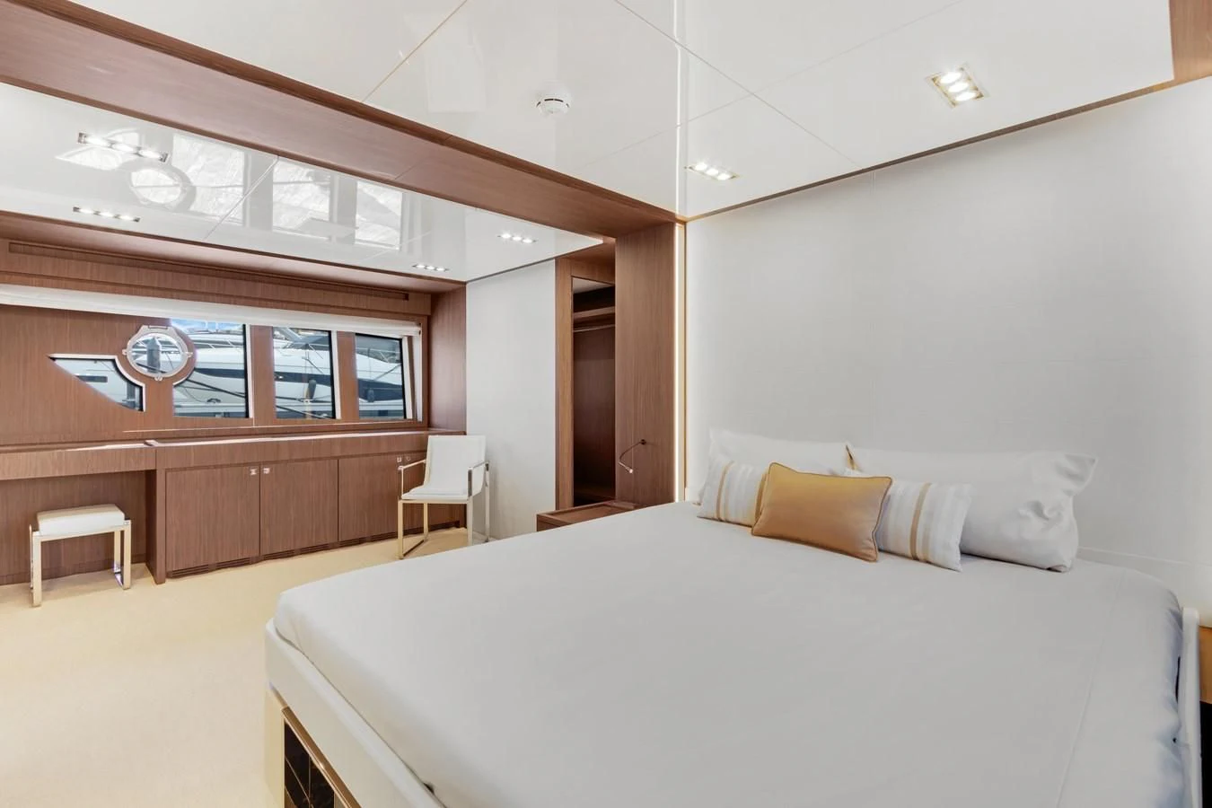 a bed with a white bed spread aboard INDISCRETION Yacht for Sale