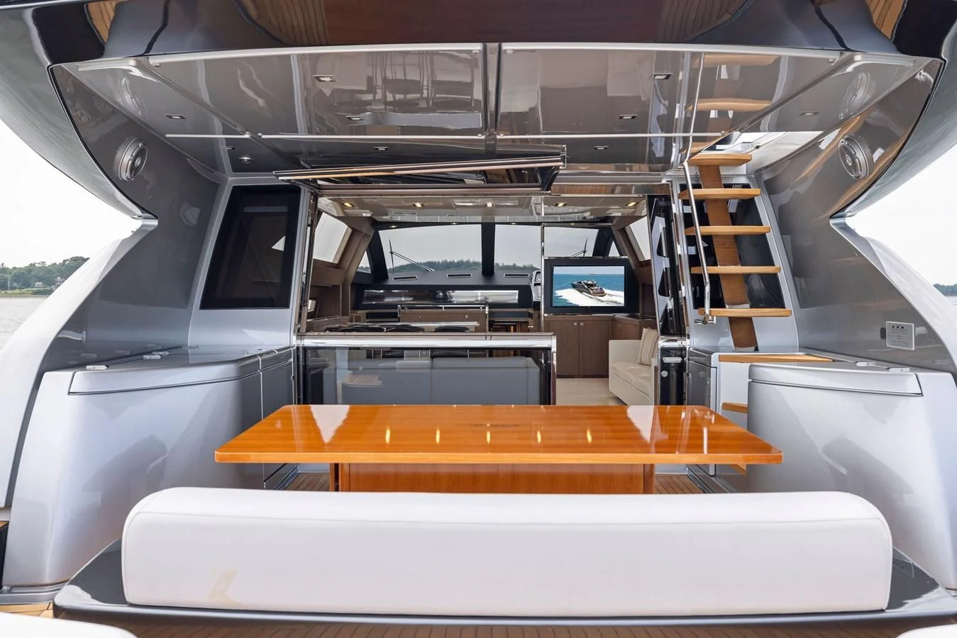 a room with a table and a shelf with books on it aboard INDISCRETION Yacht for Sale