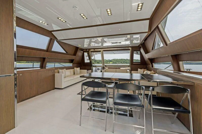 a room with a table and chairs aboard INDISCRETION Yacht for Sale