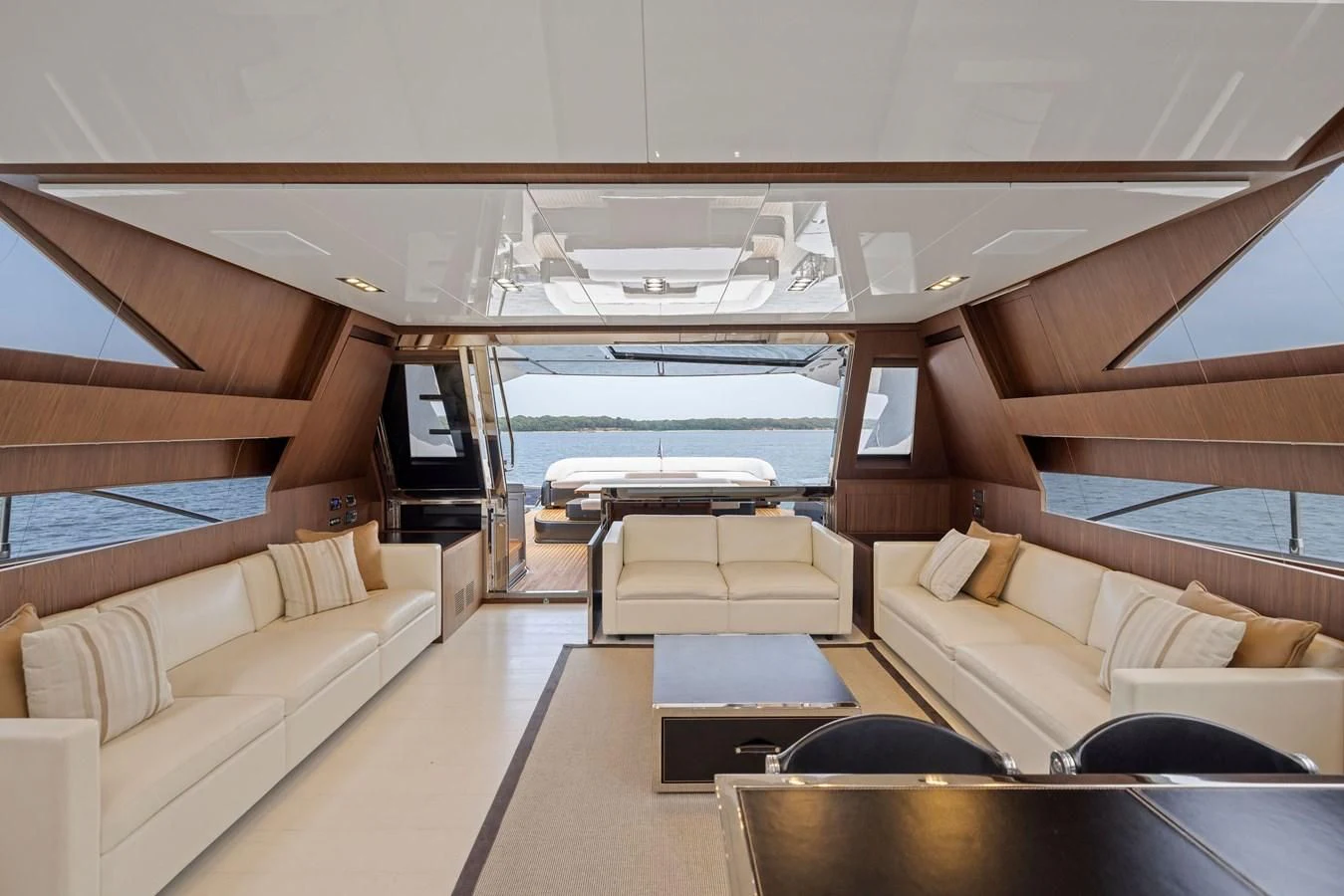 a room with a couch and a table and a large window aboard INDISCRETION Yacht for Sale