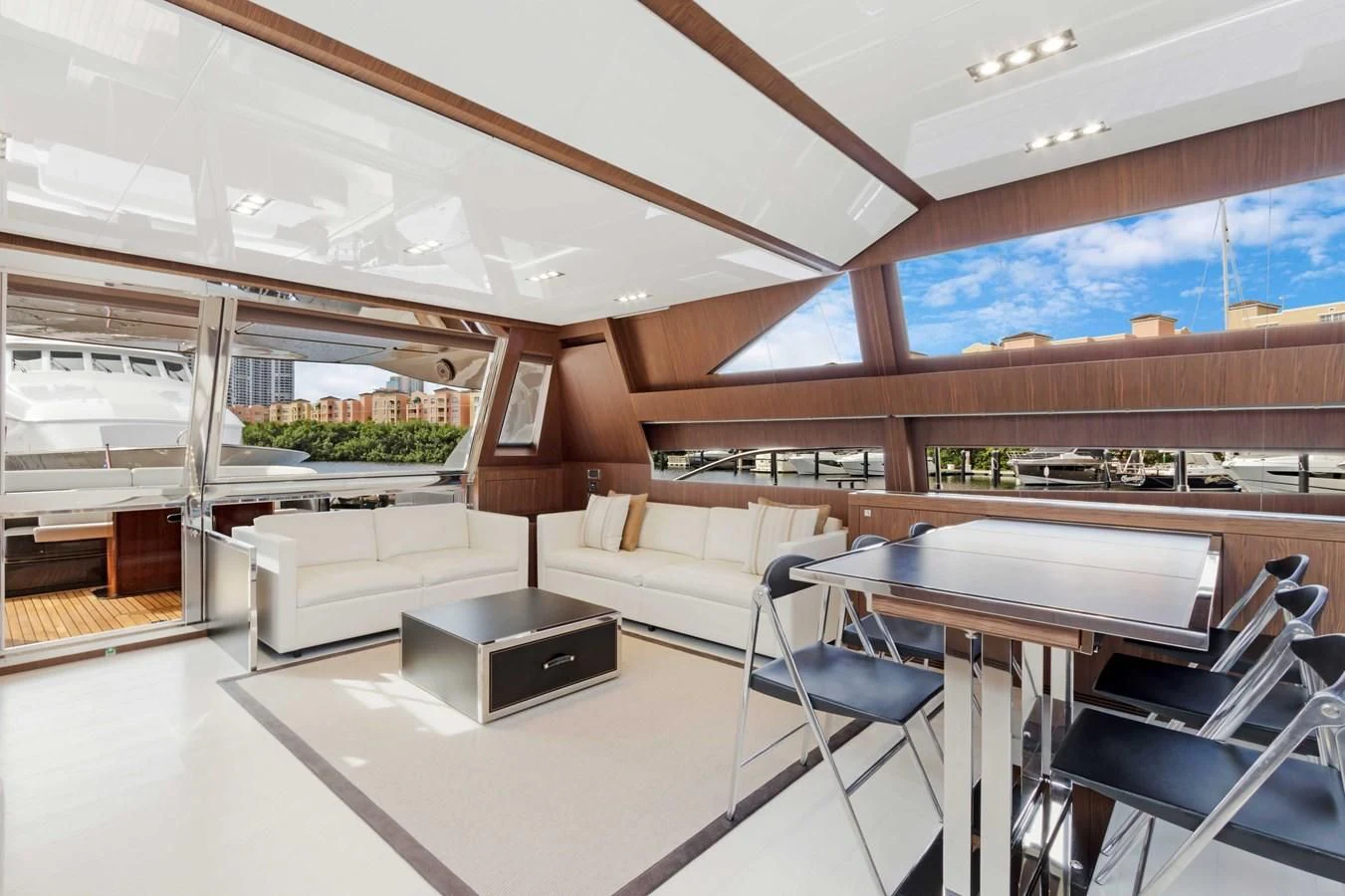 a room with a couch and a table and chairs aboard INDISCRETION Yacht for Sale