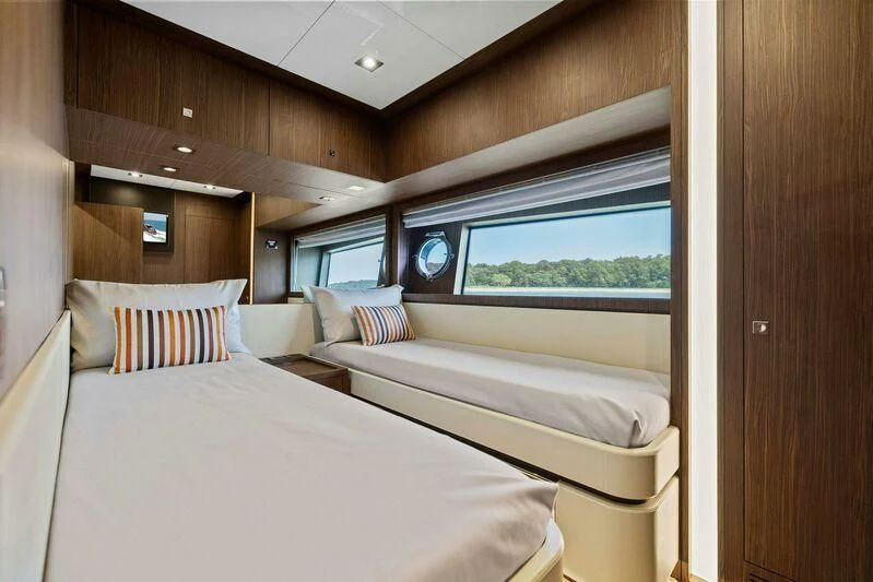 a room with beds and a window aboard INDISCRETION Yacht for Sale