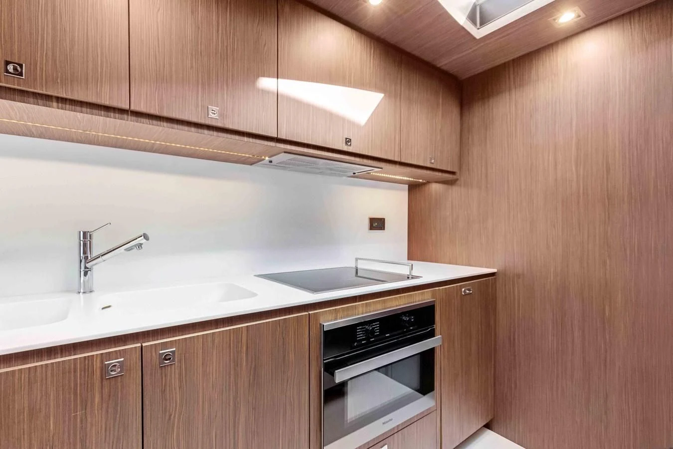a kitchen with wooden cabinets aboard INDISCRETION Yacht for Sale