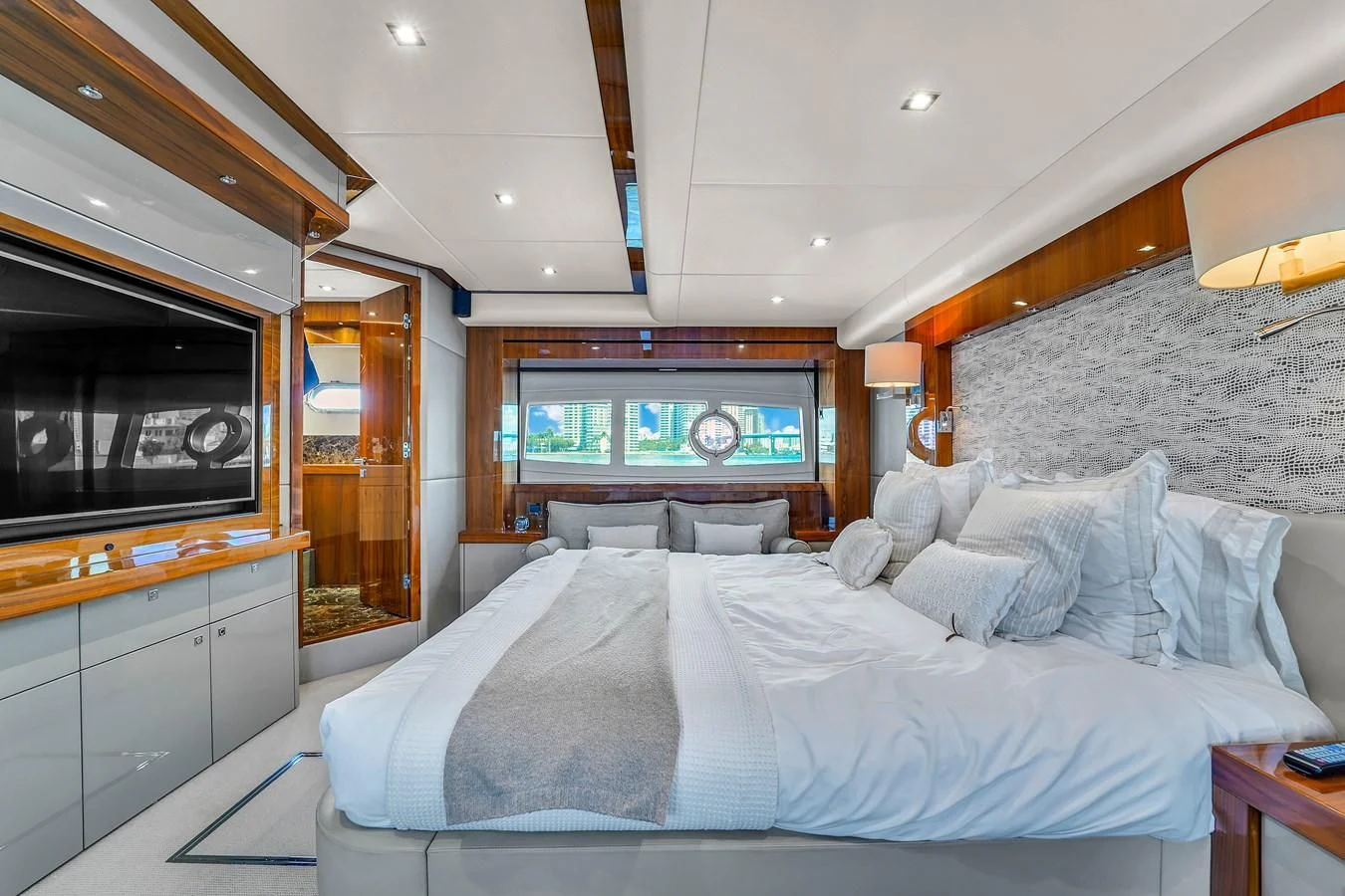 a bedroom with a bed and a television aboard 92' SUNSEEKER 2016 Yacht for Sale