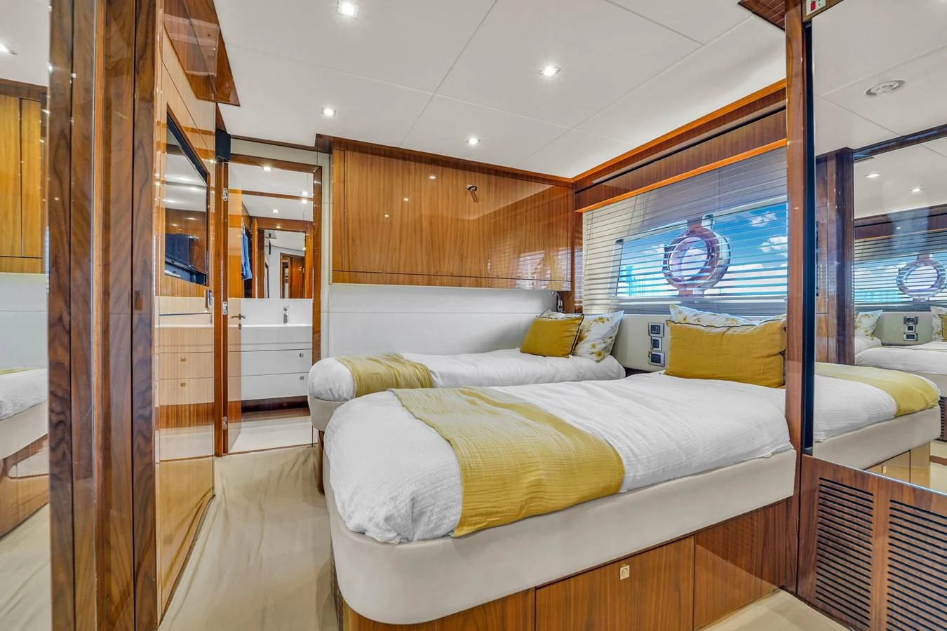 a bedroom with a bed and a glass wall aboard 92' SUNSEEKER 2016 Yacht for Sale