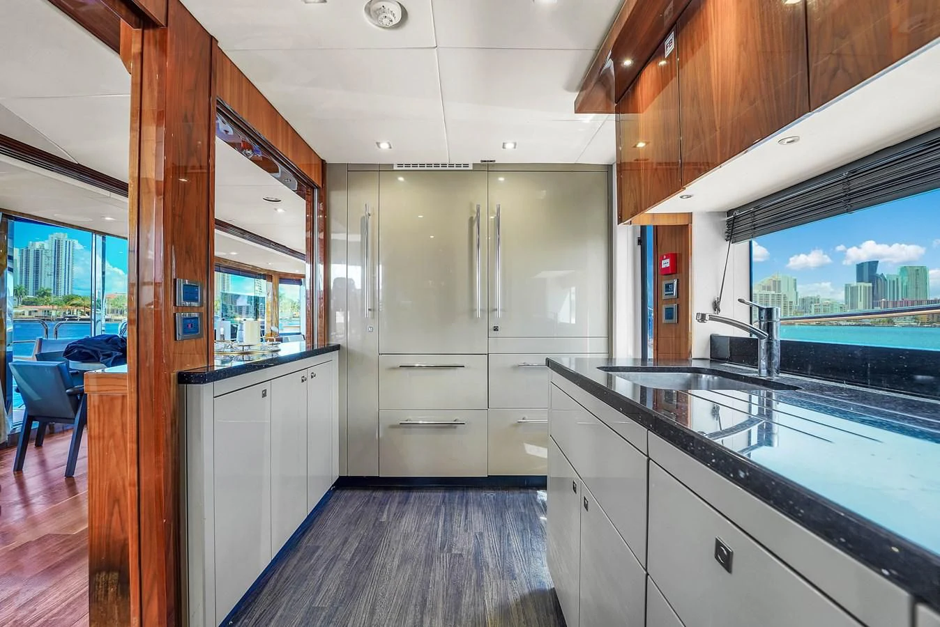 a kitchen with white cabinets aboard 92' SUNSEEKER 2016 Yacht for Sale