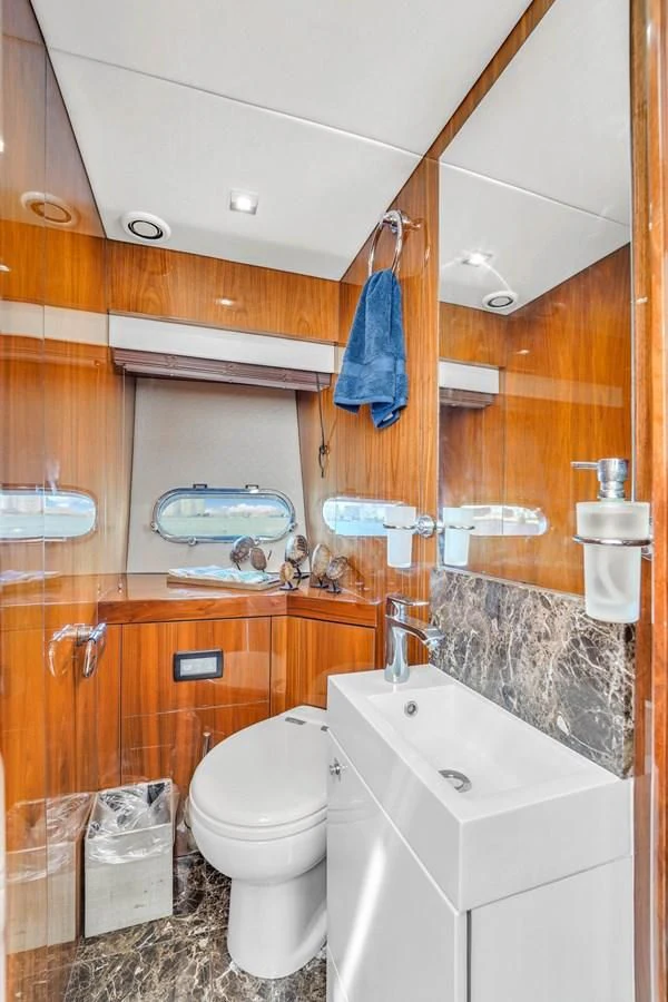 a bathroom with a toilet and sink aboard 92' SUNSEEKER 2016 Yacht for Sale
