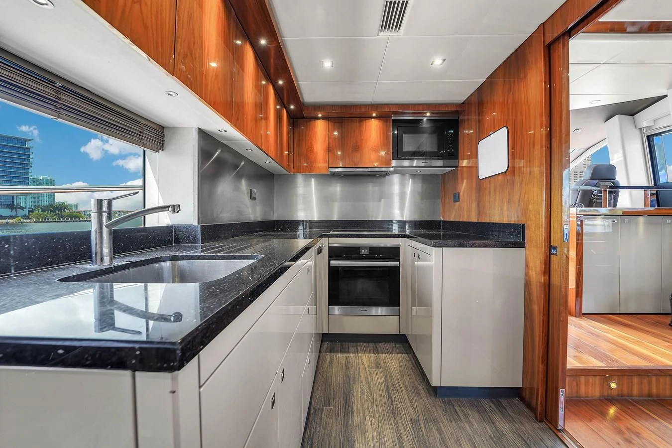 a kitchen with a wood floor aboard 92' SUNSEEKER 2016 Yacht for Sale