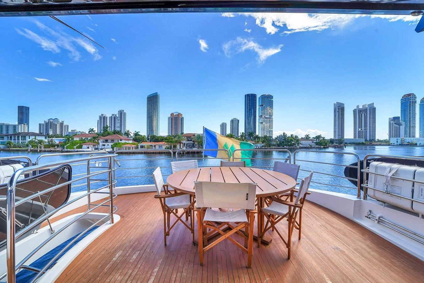 a table and chairs on a deck overlooking a city aboard 92' SUNSEEKER 2016 Yacht for Sale