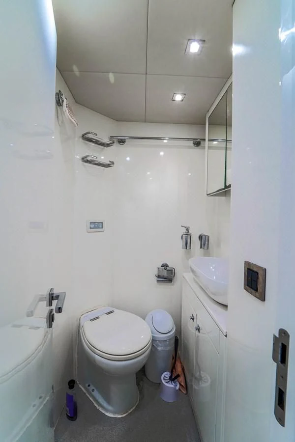 a bathroom with a toilet and sink aboard 92' SUNSEEKER 2016 Yacht for Sale