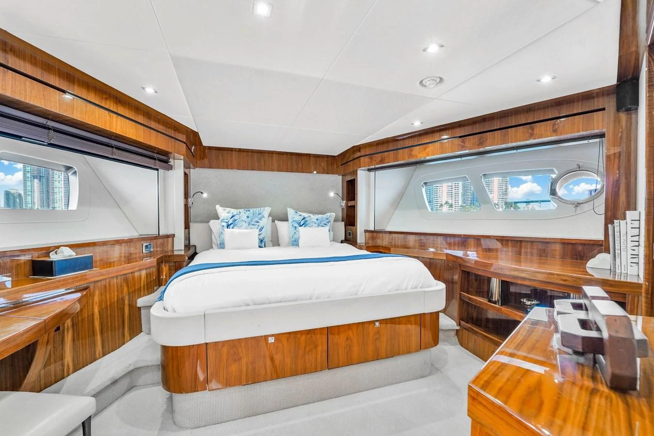 a room with a bed and a table aboard 92' SUNSEEKER 2016 Yacht for Sale