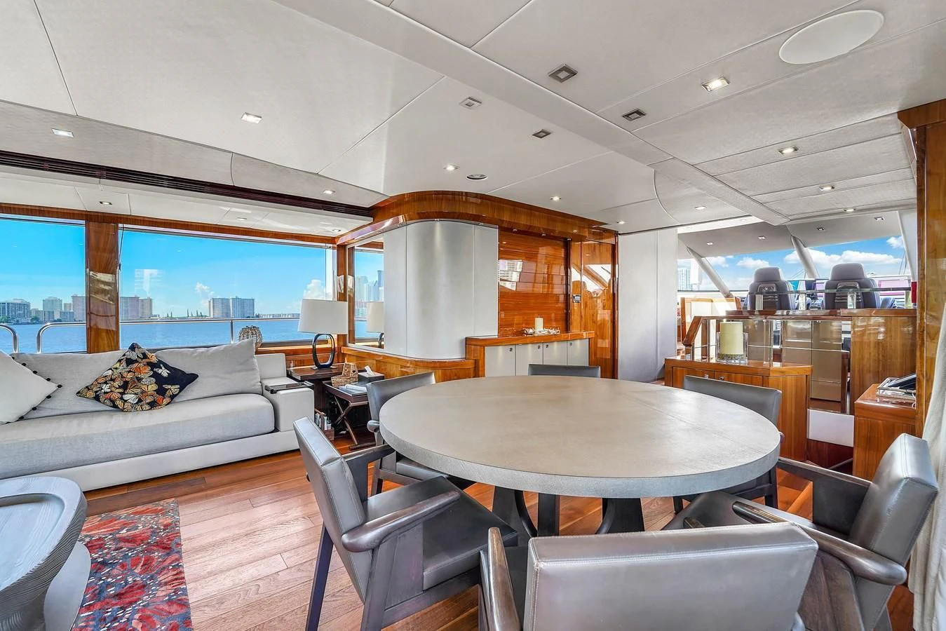 a living room with a table and chairs aboard 92' SUNSEEKER 2016 Yacht for Sale