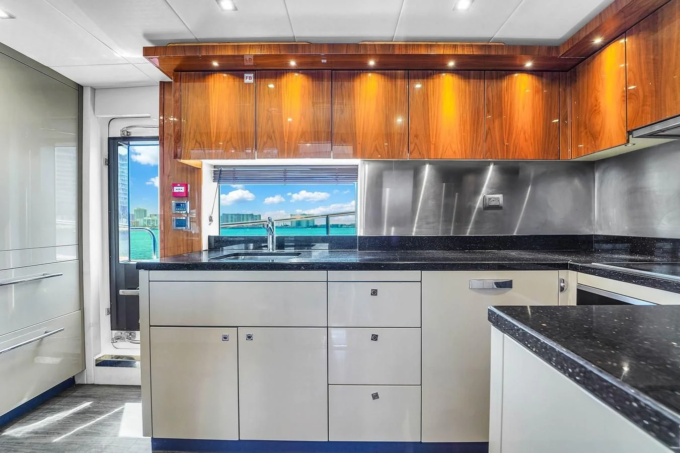 a kitchen with black counter tops aboard 92' SUNSEEKER 2016 Yacht for Sale