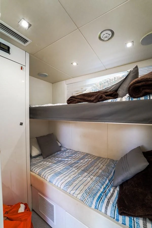 a bed with a blue blanket aboard 92' SUNSEEKER 2016 Yacht for Sale