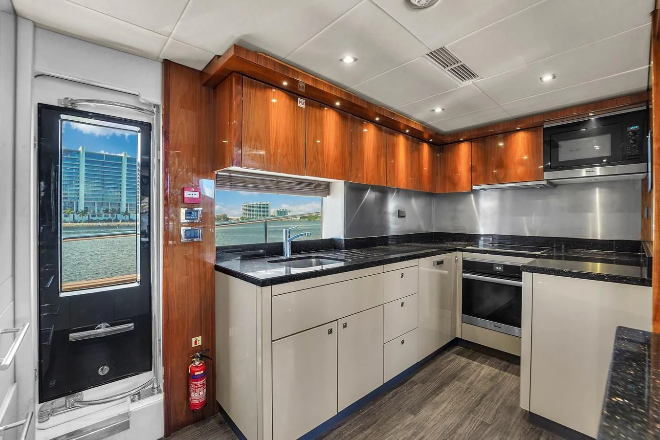 a kitchen with wooden cabinets aboard 92' SUNSEEKER 2016 Yacht for Sale