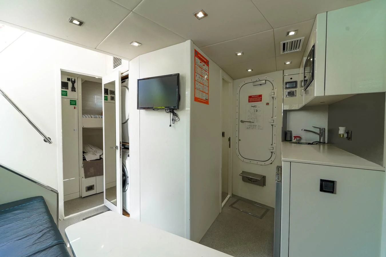a room with a tv and a door aboard 92' SUNSEEKER 2016 Yacht for Sale