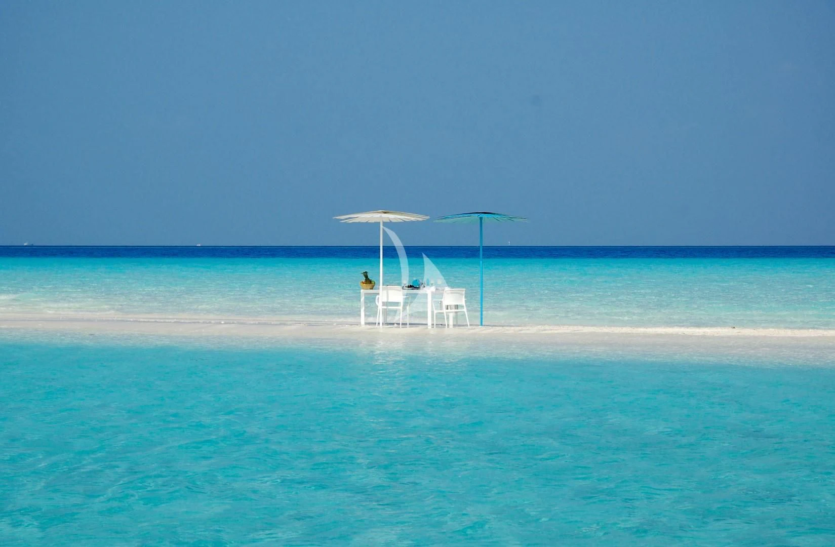 a white umbrella on a beach aboard AZALEA Yacht for Sale