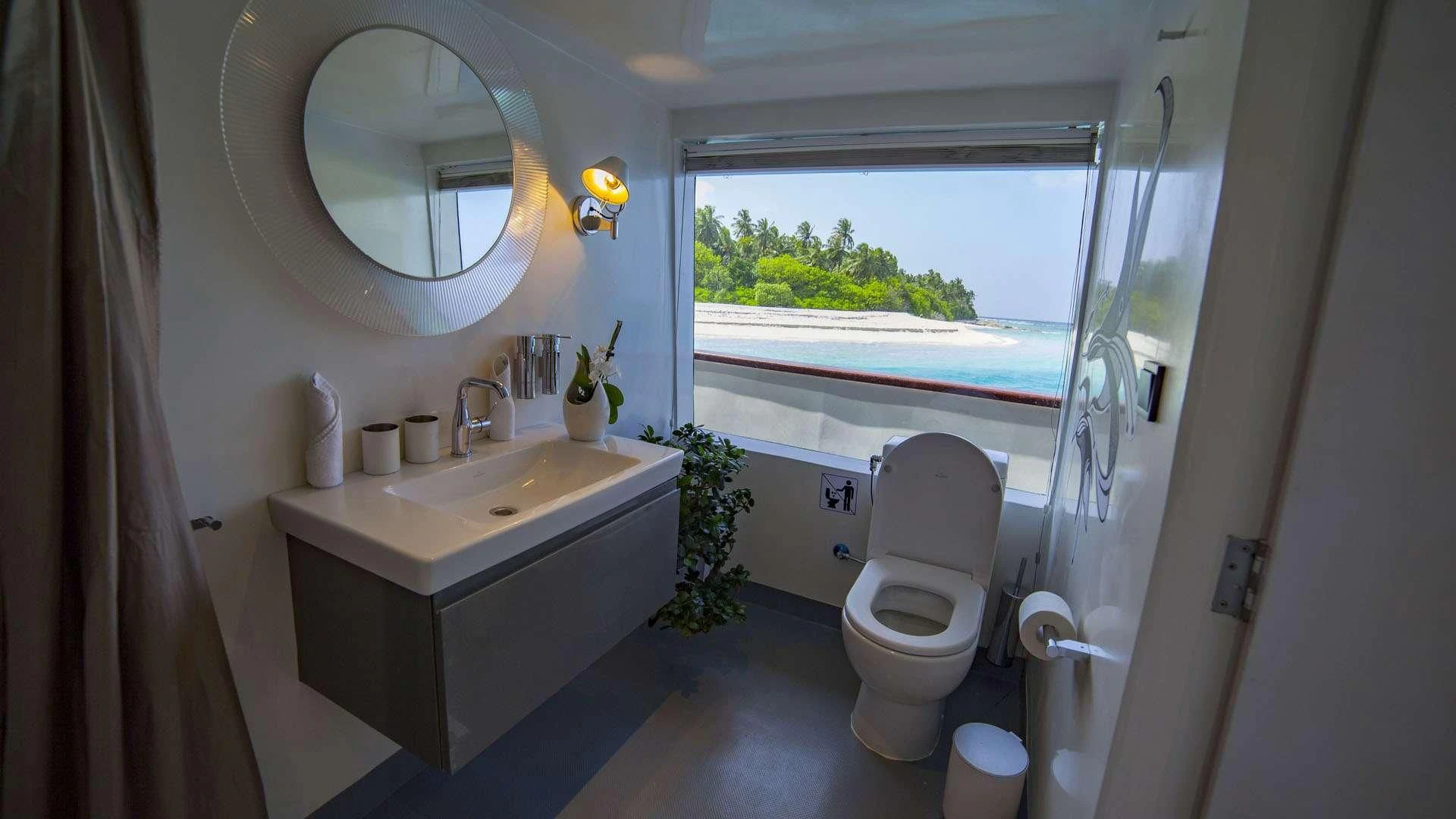a bathroom with a sink toilet and a window aboard AZALEA Yacht for Sale