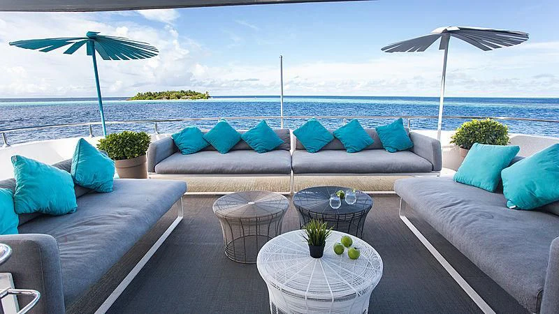 a patio with a couch and umbrella aboard AZALEA Yacht for Sale