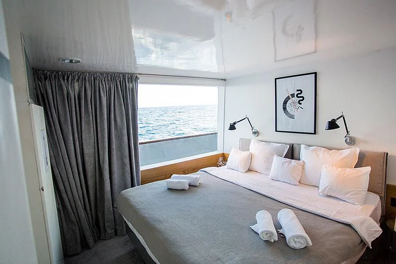 a bed with pillows and a blanket aboard AZALEA Yacht for Sale