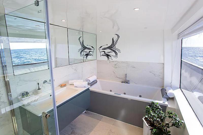 a bathroom with a large glass shower aboard AZALEA Yacht for Sale