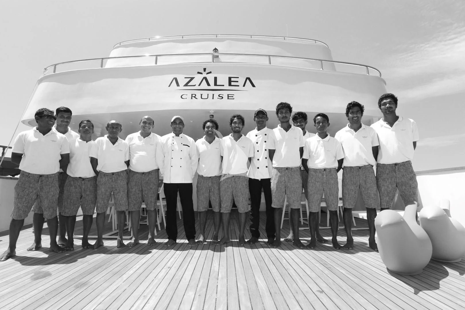 a group of people standing in front of a helicopter aboard AZALEA Yacht for Sale