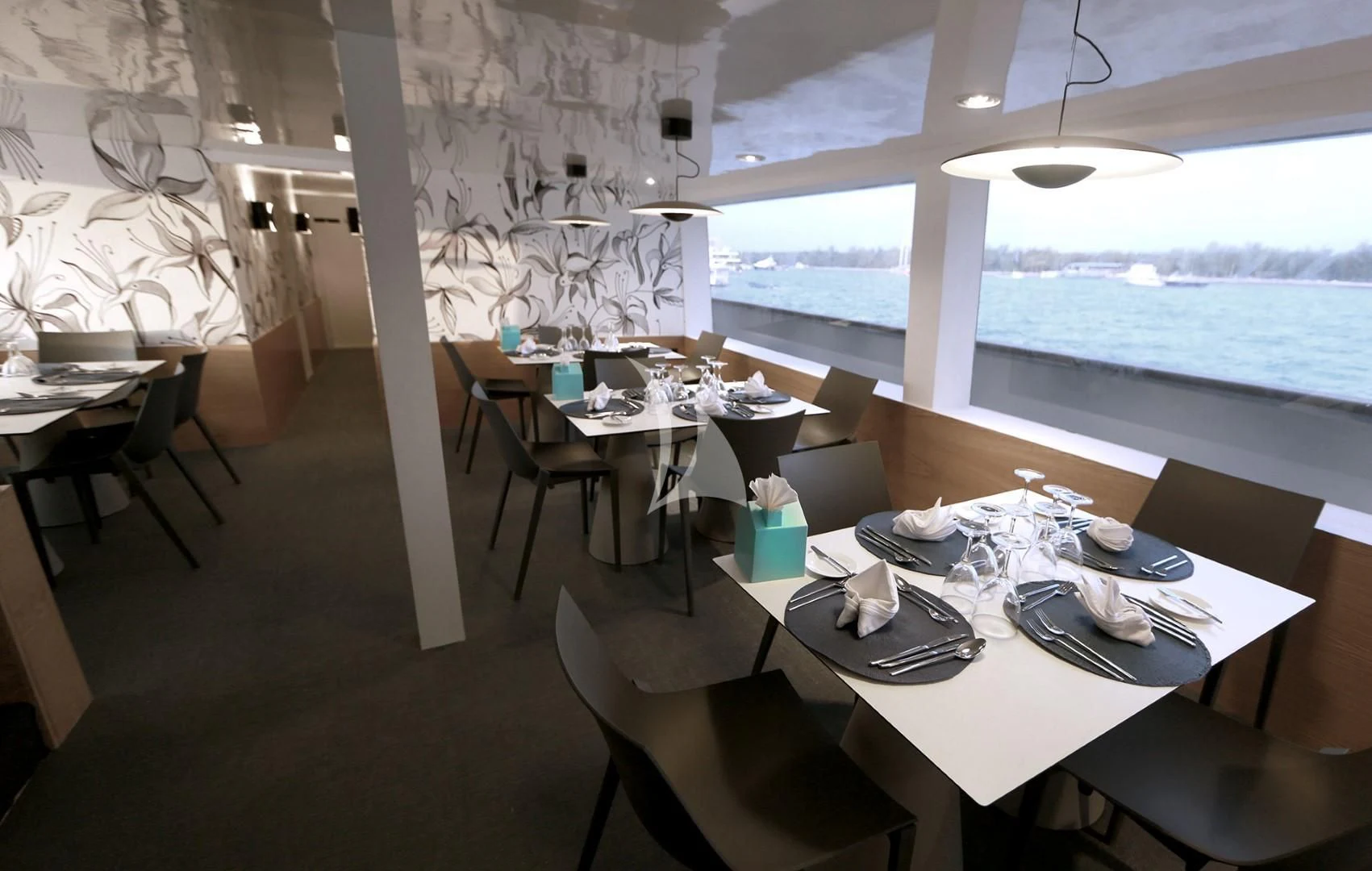 a room with tables and chairs aboard AZALEA Yacht for Sale