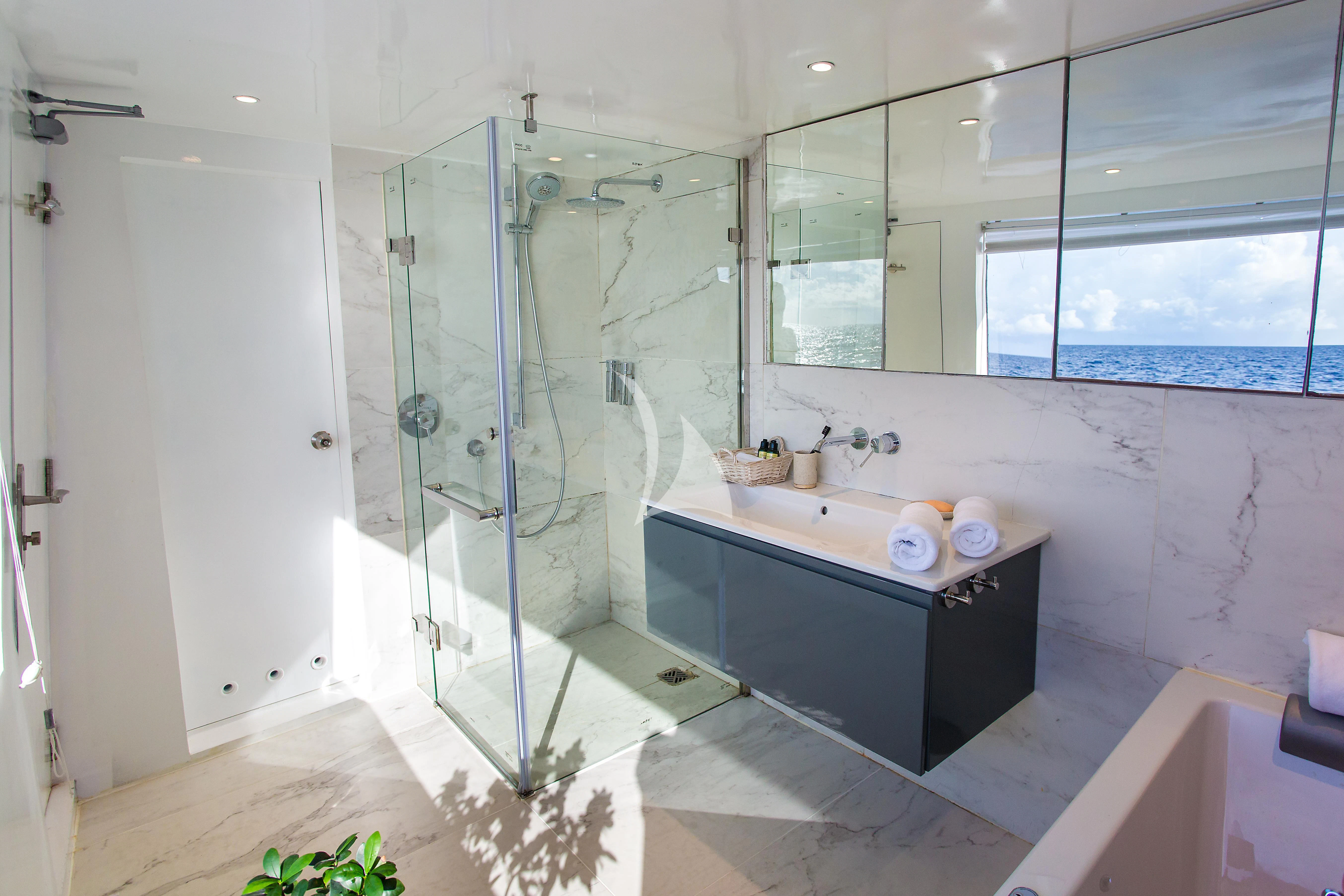 a bathroom with a glass shower aboard AZALEA Yacht for Sale