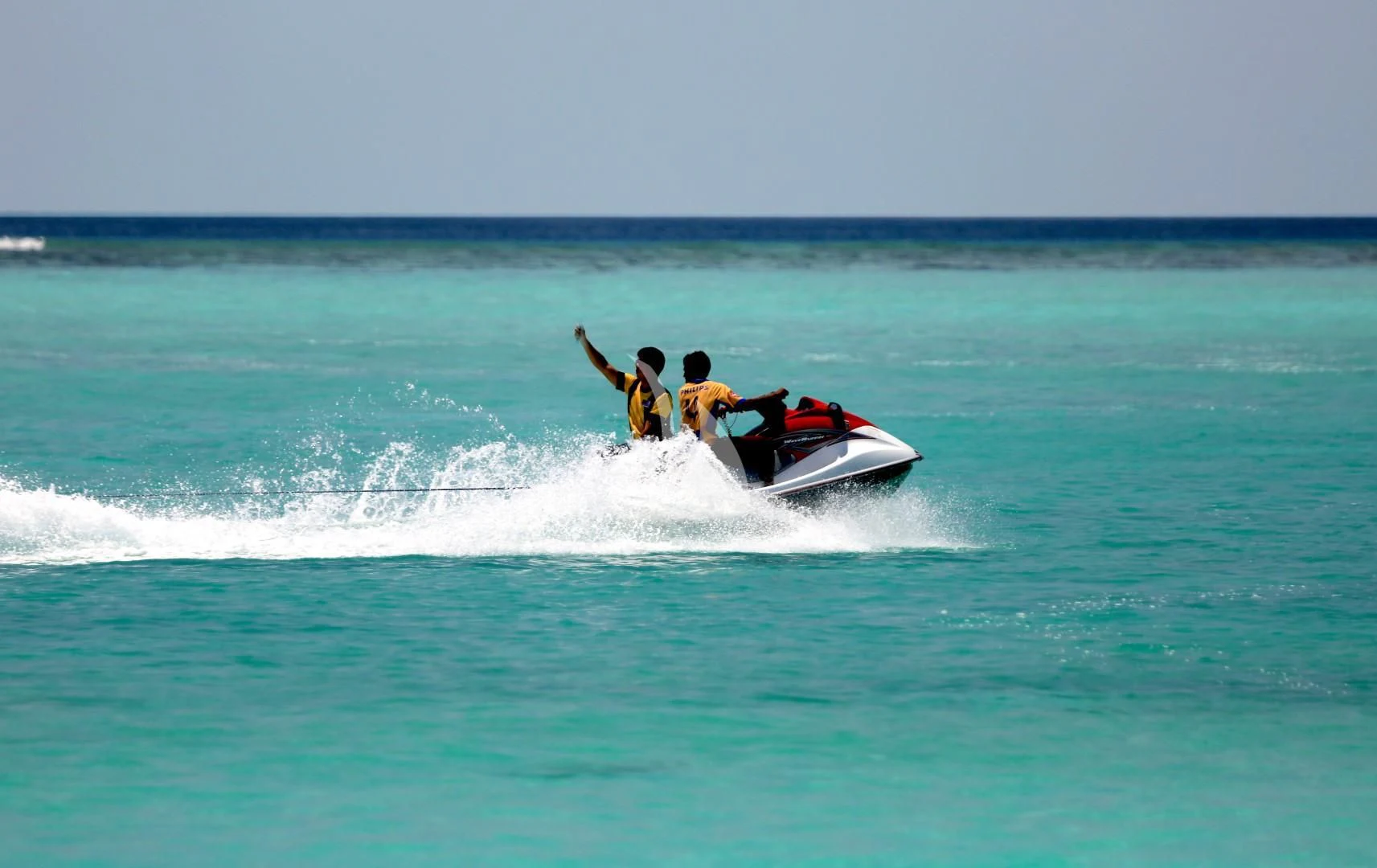 a man and a woman on a jet ski in the ocean aboard AZALEA Yacht for Sale