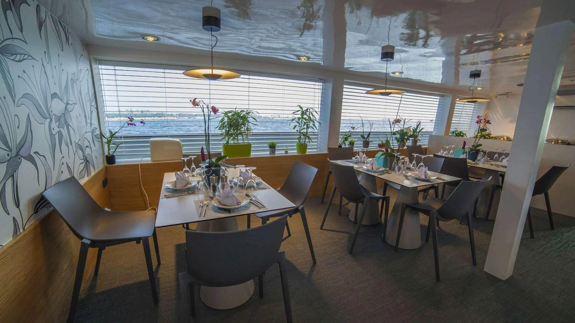 a room with tables and chairs aboard AZALEA Yacht for Sale