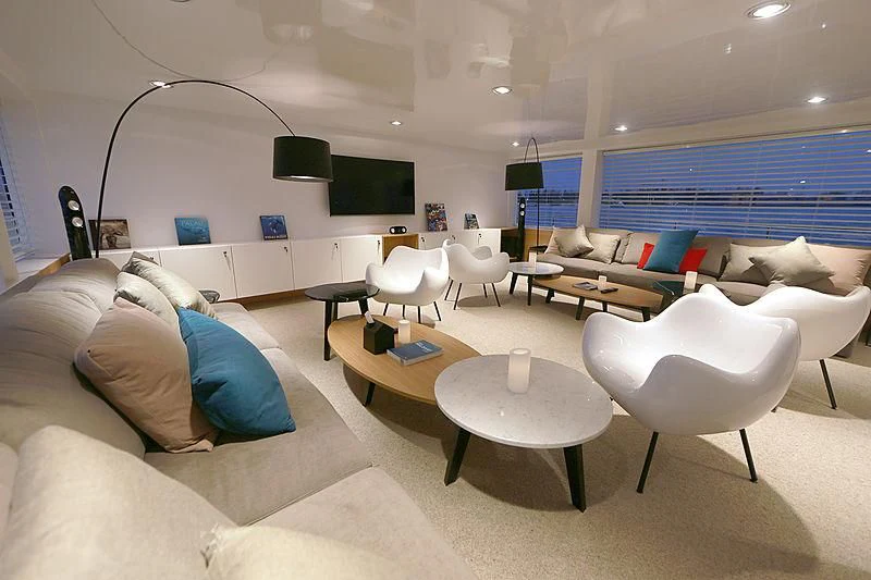 a room with a couch and a table and chairs aboard AZALEA Yacht for Sale