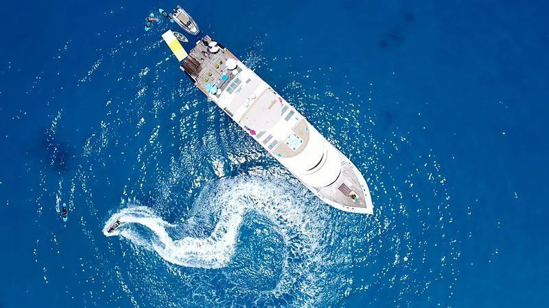 a bottle of champagne floating in the air aboard AZALEA Yacht for Sale