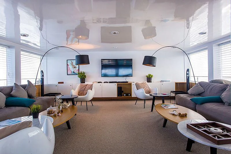 a living room with a large screen aboard AZALEA Yacht for Sale
