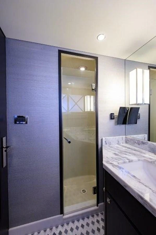 a bathroom with a glass shower aboard ODYSSEY Yacht for Sale